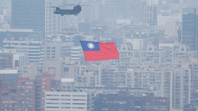 China-Taiwan Conflict: A Chinook helicopter carrying a Taiwan flag flies over the city during the country's National Day celebration in Taipei, Taiwan. (Reuters)
