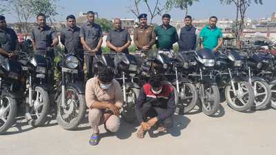 The two accused in police custody along with recovered bikes. (HT Photo)