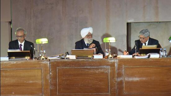 Retired judges participating in the staged hearing on stubble-burning at the Open Hand monument in Chandigarh. (Keshav Singh/HT )