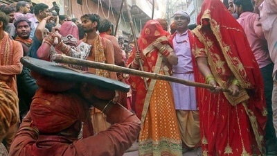 Women of Barsana beating men of Nandgaon with sticks during Lathmar Holi celebration. (ANI) Women of Barsana beating men of Nandgaon with sticks during Lathmar Holi celebration. (ANI)