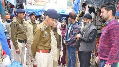 Deputy inspector general of police (central range) Madhusudhan Sharma interacts with locals in Manikaran, Kullu, on Monday. (Aqil Khan/HT) Deputy inspector general of police (central range) Madhusudhan Sharma interacts with locals in Manikaran, Kullu, on Monday. (Aqil Khan/HT)
