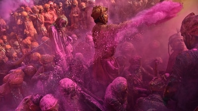 Devotees smeared in coloured powder. (REUTERS)