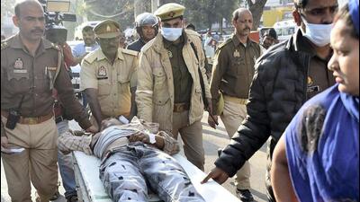 Vijay alias ‘Usman’, an accused in the Umesh Pal murder case, being brought to a hospital after allegedly being shot in an encounter by police personnel, in Prayagraj, Monday. He was rushed to the hospital where doctors declared him dead, according to officials. (PTI Photo) Vijay alias ‘Usman’, an accused in the Umesh Pal murder case, being brought to a hospital after allegedly being shot in an encounter by police personnel, in Prayagraj, Monday. He was rushed to the hospital where doctors declared him dead, according to officials. (PTI Photo)