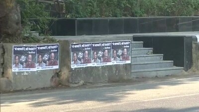 Posters targeting AAP leaders Manish Sisodia and Satyendar Jain put up outside AICC and Delhi Congress offices. (ANI)