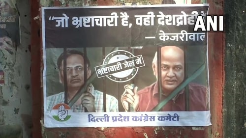 Posters targeting AAP leaders Manish Sisodia and Satyendar Jain put up outside AICC and Delhi Congress offices. (ANI)