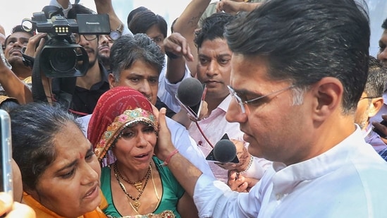 Wives of martyrs of the Pulwama Attack meet senior Congress leader Sachin Pilot at his residence, in Jaipur, Monday. (PTI)