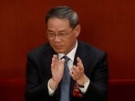 Li Qiang applauds at the opening session of the National People's Congress (NPC) at the Great Hall of the People in Beijing, China March 5, 2023. 