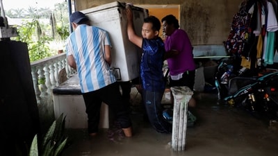 People move a refrigerator from a flooded house. Malaysia often experiences stormy weather towards the year end, with seasonal flooding regularly causing mass evacuations and deaths. (Hasnoor Hussain / Reuters) People move a refrigerator from a flooded house. Malaysia often experiences stormy weather towards the year end, with seasonal flooding regularly causing mass evacuations and deaths. (Hasnoor Hussain / Reuters)