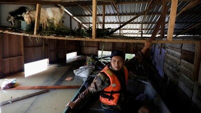 Saifulamri Tumiran, a volunteer, leaves a house after feeding goats trapped on the ceiling of the house. The Meteorological Department has said the country was experiencing its sixth episode of continuous heavy rain from the annual monsoon season that started in November last year. In December, tens of thousands of people were also evacuated due to flooding, reported AP. (Hasnoor Hussain / Reuters) Saifulamri Tumiran, a volunteer, leaves a house after feeding goats trapped on the ceiling of the house. The Meteorological Department has said the country was experiencing its sixth episode of continuous heavy rain from the annual monsoon season that started in November last year. In December, tens of thousands of people were also evacuated due to flooding, reported AP. (Hasnoor Hussain / Reuters)