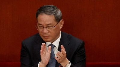 Li Qiang applauds at the opening session of the National People's Congress (NPC) at the Great Hall of the People in Beijing, China March 5, 2023. (REUTERS)