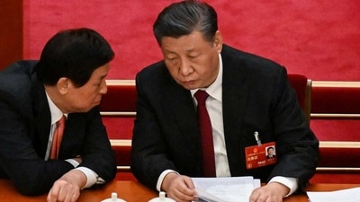 China's President Xi Jinping (R) speaks with National People's Congress Chairman Li Zhanshu. (AFP)