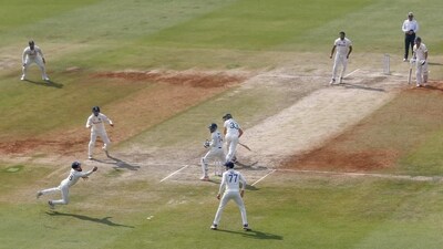 India's Virat Kohli, left, dives to stop a ball during the third day of third cricket test match between India and Australia in Indore (AP)