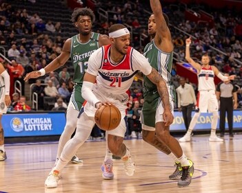 Washington Wizards center Daniel Gafford (21) controls the ball in front of Detroit Pistons center James Wiseman (13) and guard Rodney McGruder (17) in the first quarter at Little Caesars Arena. (USA TODAY Sports)