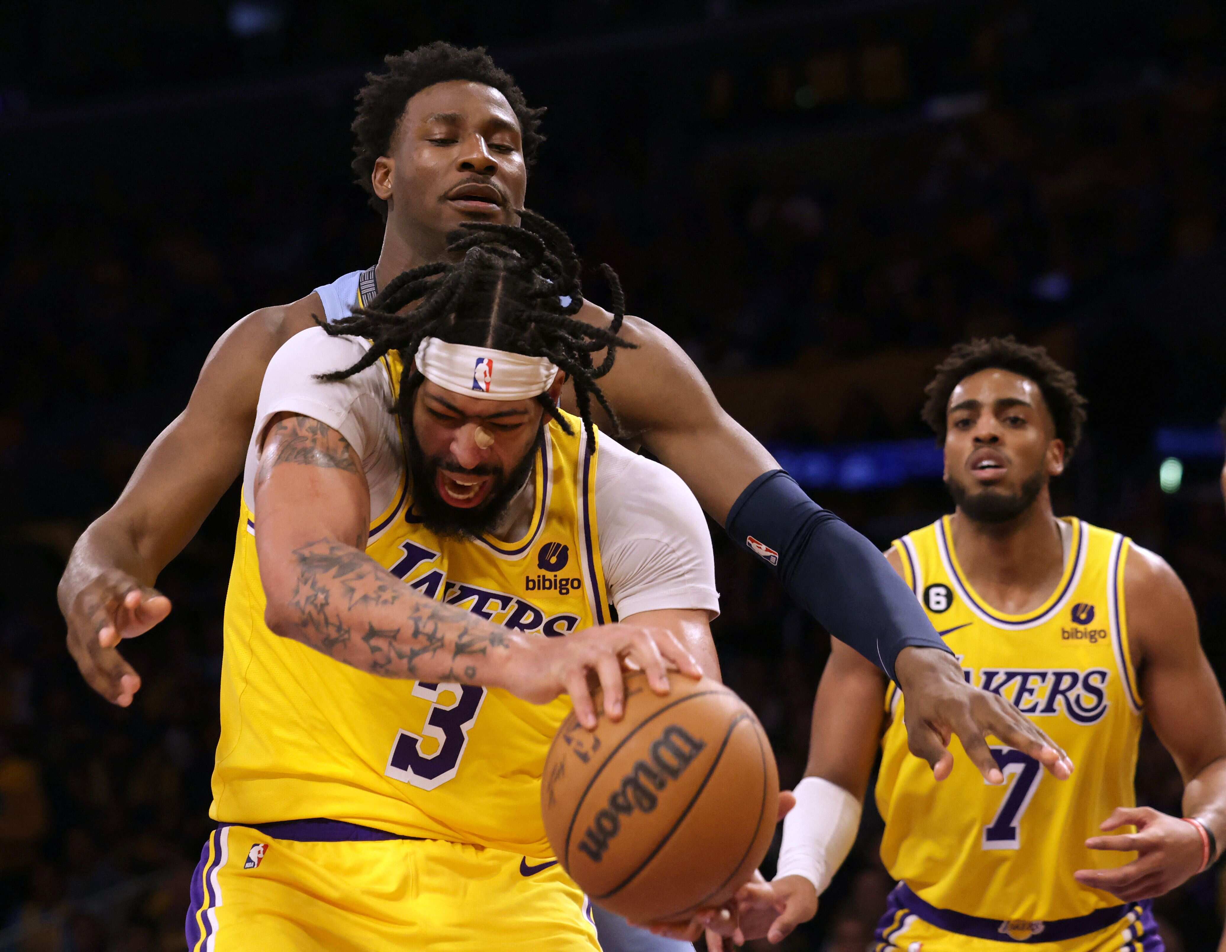 Anthony Davis #3 of the Los Angeles Lakers takes a rebound from Jaren Jackson Jr. #13 of the Memphis Grizzlies during a 112-103 Lakers win at Crypto.com Arena. (Getty Images via AFP) Anthony Davis #3 of the Los Angeles Lakers takes a rebound from Jaren Jackson Jr. #13 of the Memphis Grizzlies during a 112-103 Lakers win at Crypto.com Arena. (Getty Images via AFP)