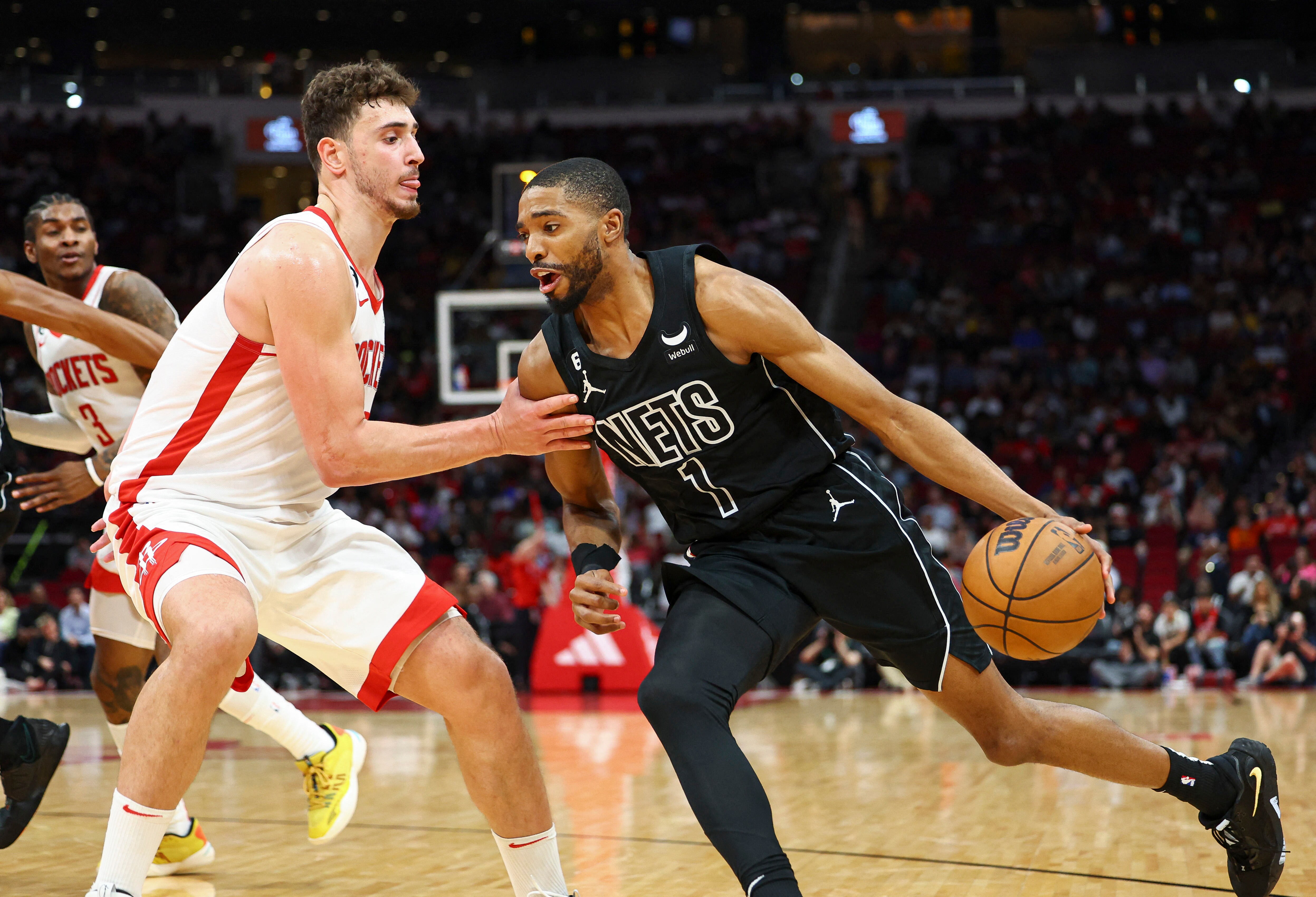 Brooklyn Nets forward Mikal Bridges (1) dribbles the ball as Houston Rockets center Alperen Sengun (28) defends during the third quarter at Toyota Center. (USA TODAY Sports)