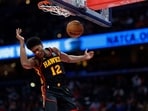 Atlanta Hawks forward De'Andre Hunter (12) dunks the ball against the Washington Wizards in the second quarter at Capital One Arena..