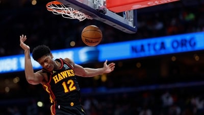 Atlanta Hawks forward De'Andre Hunter (12) dunks the ball against the Washington Wizards in the second quarter at Capital One Arena.. (USA TODAY Sports)