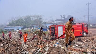 Fire and rescue personnel at Brahmapuram waste treatment plant, in Kochi. (PTI) Fire and rescue personnel at Brahmapuram waste treatment plant, in Kochi. (PTI)