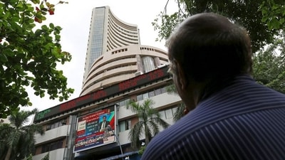 A man looks at a screen across a road displaying the Sensex on the facade of the Bombay Stock Exchange (BSE) building in Mumbai. (REUTERS)