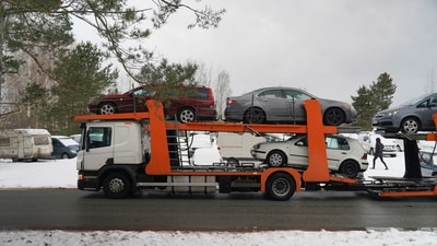 A trailer loaded with vehicles to send to Ukraine, which were confiscated from drunk drivers, in Riga, Latvia. (Reuters)