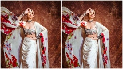 Styled by fashion stylist Maneka Hari Singhani, Malaika wore her tresses into a clean bun and decked up in orange eyeshadow, black eyeliner, mascara-laden eyelashes, contoured cheeks and a shade of nude lipstick. (Instagram/@malaikaaroraofficial) Styled by fashion stylist Maneka Hari Singhani, Malaika wore her tresses into a clean bun and decked up in orange eyeshadow, black eyeliner, mascara-laden eyelashes, contoured cheeks and a shade of nude lipstick. (Instagram/@malaikaaroraofficial)