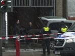 Morticians bring a covered stretcher to their vehicle at a building used by Jehovah's Witnesses in Hamburg, Germany Friday. Morticians bring a covered stretcher to their vehicle at a building used by Jehovah's Witnesses in Hamburg, Germany Friday.