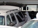 Forensic technicians load the body of an American kidnapped by gunmen in a vehicle to be transported to the U.S. border for repatriation, in Matamoros, Mexico
