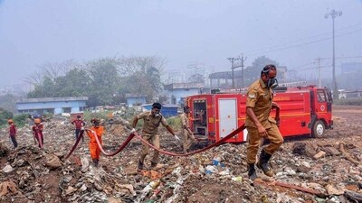 Fire and rescue personnel at Brahmapuram waste treatment plant, in Kochi. (PTI) Fire and rescue personnel at Brahmapuram waste treatment plant, in Kochi. (PTI)
