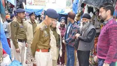 Deputy inspector general of police (central range) Madhusudhan Sharma interacting with local residents in Manikaran, Kullu, on March 6. (Aqil Khan/HT) Deputy inspector general of police (central range) Madhusudhan Sharma interacting with local residents in Manikaran, Kullu, on March 6. (Aqil Khan/HT)