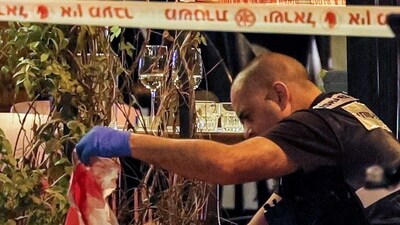 An Israeli policeman inspects a blood-stained sheet outside the venue that was the scene of a shooting attack along Dizengoff Avenue in the centre of Tel Aviv on Thursday. (AFP) An Israeli policeman inspects a blood-stained sheet outside the venue that was the scene of a shooting attack along Dizengoff Avenue in the centre of Tel Aviv on Thursday. (AFP)