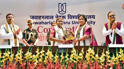 Union minister Dharmendra Pradhan, President Murmu, and JNU VC Santishree Dhulipudi Pandit at the ceremony on Friday. (ANI) Union minister Dharmendra Pradhan, President Murmu, and JNU VC Santishree Dhulipudi Pandit at the ceremony on Friday. (ANI)