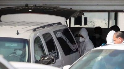 Forensic technicians load the body of an American kidnapped by gunmen in a vehicle to be transported to the U.S. border for repatriation, in Matamoros, Mexico (Reuters)