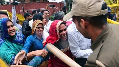 Police personnel stop widows of soldiers who lost their lives in the 2019's Pulwama terror attack during a protest, in Jaipur on Thursday. (ANI) Police personnel stop widows of soldiers who lost their lives in the 2019's Pulwama terror attack during a protest, in Jaipur on Thursday. (ANI)