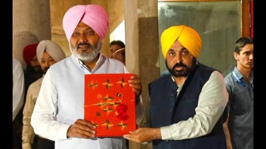 Punjab chief minister Bhagwant Mann (right) with state finance minister Harpal Singh Cheema before the budget was presented in the assembly in Chandigarh on Friday. (Ravi Kumar/HT)