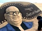 Sand artist Sudarsan Pattnaik creates a sand art of Bollywood actor-director Satish Chandra Kaushik as a tribute to him, in Puri on Thursday.