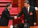 China's President Xi Jinping (R) is congrated by Politburo Standing Committee member Li Qiang after being re-elected as president for a third term during the third plenary session of the National People's Congress (NPC) in Beijing on March 10, 2023. China's President Xi Jinping (R) is congrated by Politburo Standing Committee member Li Qiang after being re-elected as president for a third term during the third plenary session of the National People's Congress (NPC) in Beijing on March 10, 2023.