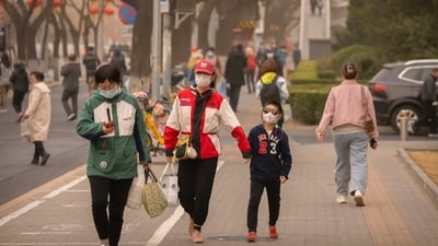 People wearing face masks walk along a street during a day with poor air quality in Beijing. Concentrations of tiny PM2.5 particles that can reach deep into the lungs and bloodstream entered a dangerous range on air quality monitoring sites, reported AP. (Mark Schiefelbein / AP) People wearing face masks walk along a street during a day with poor air quality in Beijing. Concentrations of tiny PM2.5 particles that can reach deep into the lungs and bloodstream entered a dangerous range on air quality monitoring sites, reported AP. (Mark Schiefelbein / AP)