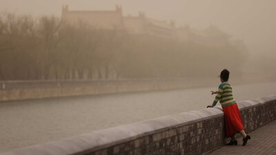 A woman poses for pictures near the Forbidden City, as the city is shrouded in smog amid a sandstorm. The capital also used to be known for regular springtime dust and sandstorms caused by winds blowing in from the loess hills along the upper sections of the Yellow River to the west. Anti-desertification efforts have helped reduce both the frequency and intensity of the storms that had often turned the surrounding air a cataclysmic yellowish-red, reported AP. (Tingshu Wang / Reuters) A woman poses for pictures near the Forbidden City, as the city is shrouded in smog amid a sandstorm. The capital also used to be known for regular springtime dust and sandstorms caused by winds blowing in from the loess hills along the upper sections of the Yellow River to the west. Anti-desertification efforts have helped reduce both the frequency and intensity of the storms that had often turned the surrounding air a cataclysmic yellowish-red, reported AP. (Tingshu Wang / Reuters)