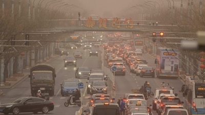 Cars and pedestrians navigate along a street shrouded in dust and haze in Beijing. China has been promoting coal-fired power, setting back efforts to cut climate-changing carbon emissions from the biggest global source. The country is also a top producer and consumer of coal and the biggest source of air pollution and climate-changing gasses, reported AP. (Mark Schiefelbein / AP) Cars and pedestrians navigate along a street shrouded in dust and haze in Beijing. China has been promoting coal-fired power, setting back efforts to cut climate-changing carbon emissions from the biggest global source. The country is also a top producer and consumer of coal and the biggest source of air pollution and climate-changing gasses, reported AP. (Mark Schiefelbein / AP)