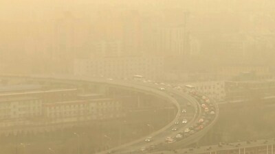 A view of a highway shot through a glass window during a dust storm. The ruling Communist Party has rejected binding emissions commitments, citing its economic development needs, and Beijing has avoided joining governments that promised to phase out use of coal-fired power, reported AP. (Borg Wong / AP) A view of a highway shot through a glass window during a dust storm. The ruling Communist Party has rejected binding emissions commitments, citing its economic development needs, and Beijing has avoided joining governments that promised to phase out use of coal-fired power, reported AP. (Borg Wong / AP)
