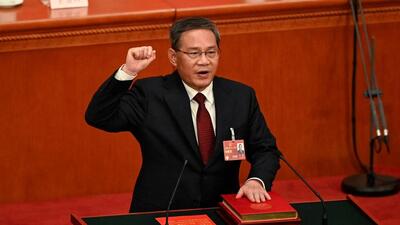 China's newly-elected Premier Li Qiang takes an oath after being elected during the fourth plenary session of the National People's Congress in Beijing on March 11, 2023. (AFP)