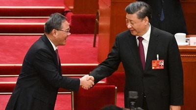 China's President Xi Jinping (R) is congrated by Politburo Standing Committee member Li Qiang after being re-elected as president for a third term during the third plenary session of the National People's Congress (NPC) in Beijing on March 10, 2023. (AFP) China's President Xi Jinping (R) is congrated by Politburo Standing Committee member Li Qiang after being re-elected as president for a third term during the third plenary session of the National People's Congress (NPC) in Beijing on March 10, 2023. (AFP)