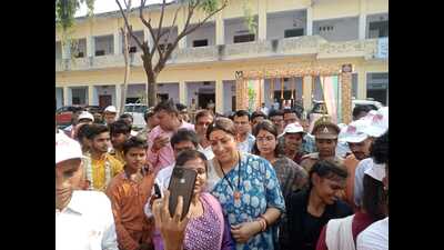 Union minister Smriti Irani poses for a selfie with a local woman in Amethi on Saturday. (HT Photo)