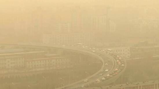 A view of a highway shot through a glass window during a dust storm. The ruling Communist Party has rejected binding emissions commitments, citing its economic development needs, and Beijing has avoided joining governments that promised to phase out use of coal-fired power, reported AP.&nbsp;(Borg Wong / AP)