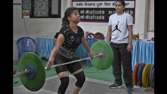 A player in action during the 39th edition of the Ludhiana Weightlifting Championship. (Gurpreet Singh/HT PHOTO)