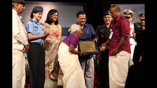 Kuttiyamma Konthi, 106, receives her award at the DCW event in New Delhi on Saturday. (HT PHOTO)