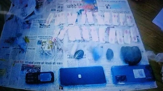 Picture showing seized drugs, mobiles, and other possessions. (ANI)