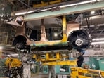 Workers install a battery for a new electric vehicle model at Mitsubishi Motor Corp's factory in Kurashiki, Japan.