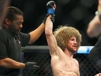 Merab Dvalshvili (blue gloves) reacts after fighting Petr Yan (red gloves) during UFC Fight Night at Virgin Hotel.