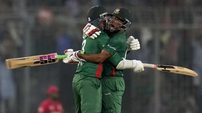 Bangladesh's Najmul Hossain Shanto, right, and Taskin Ahmed celebrate after their win in the the second T20 cricket match against England in Dhaka, Bangladesh, Sunday, March 12, 2023. (AP Photo/Aijaz Rahi) (AP)